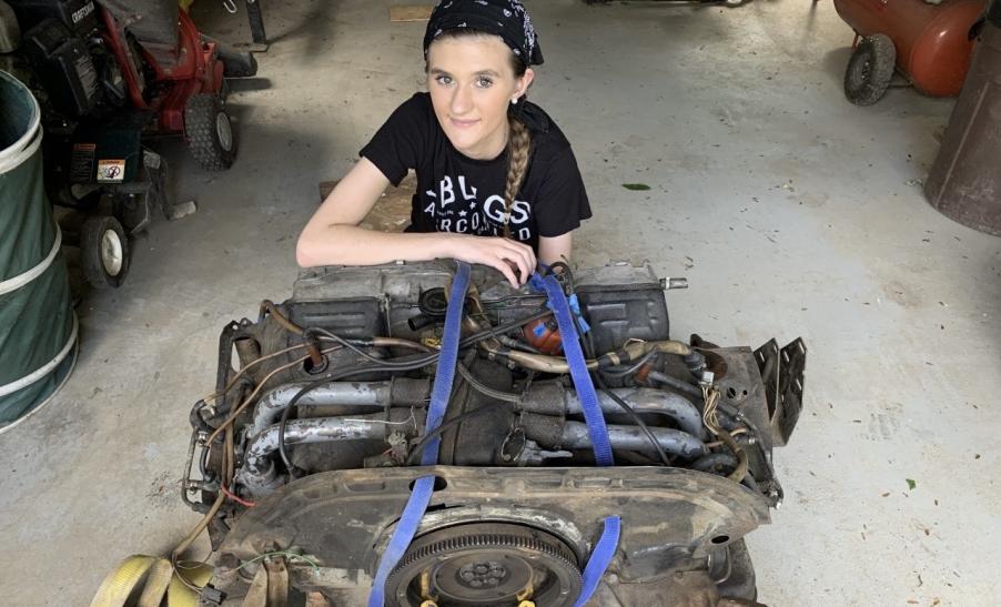 Allie in front of an engine she's working to transition. 