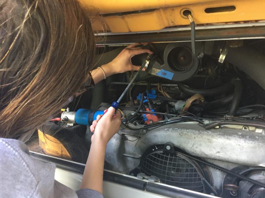 Chloe working on transitioning a gas engine to electric. 