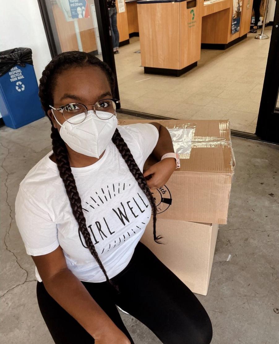 Girl sitting next to boxes